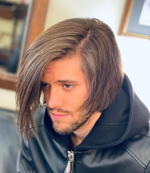 Asimetrični dugi bob za muškarce s prirodnim padom i elegantnim razdjeljkom.