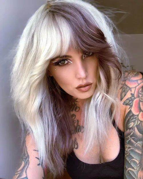 E-girl shag frizura s tamnim i svijetlim blok pramenovima koji naglašavaju teksturu i kontrast.